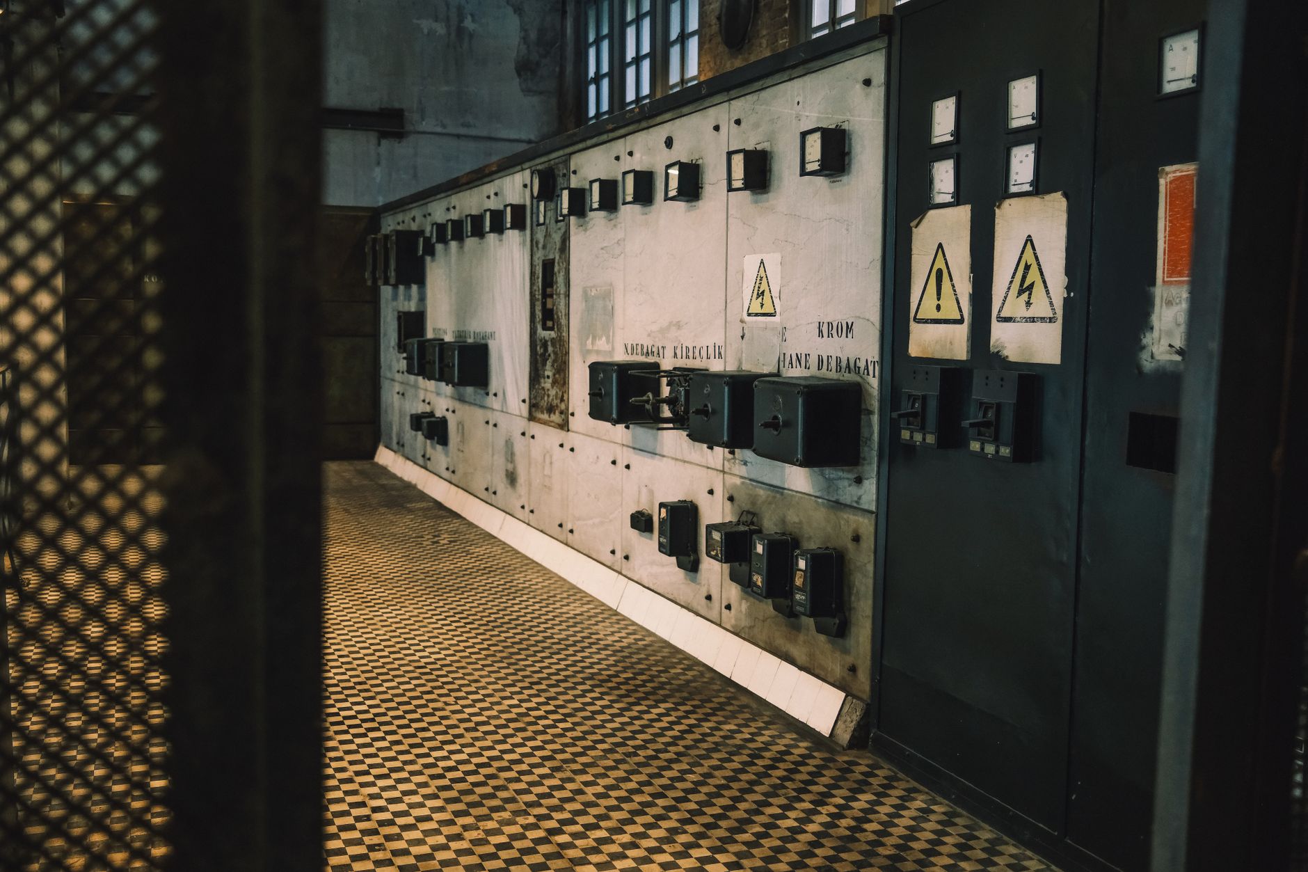 Sunlight streaming through broken windows into the interior of an abandoned industrial building