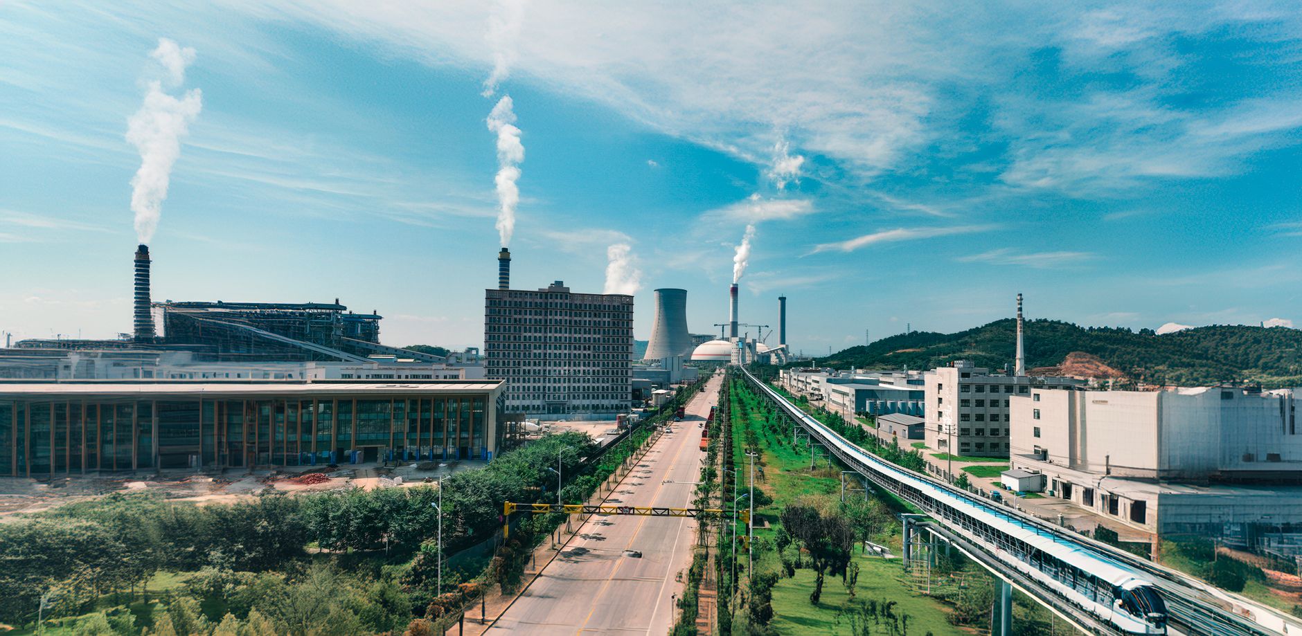 Weathered brick factory building with tall smokestacks under an overcast sky in Northeast China